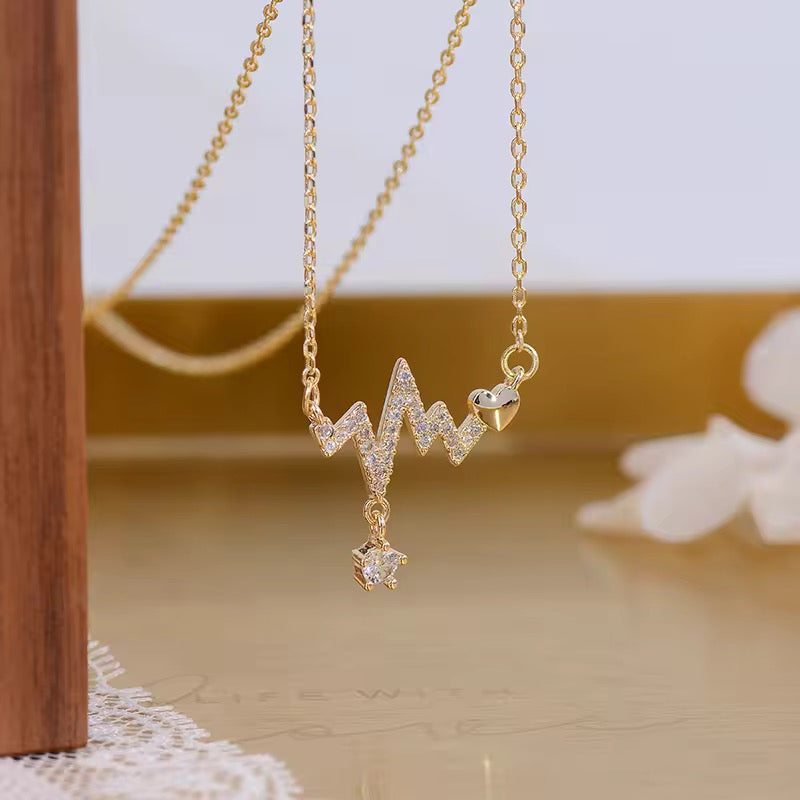 Everyday necklace with heartbeat charm in waterproof gold-plated steel, designed for meaningful wear