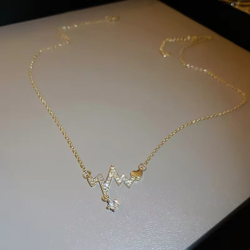 Heartbeat necklace featuring sleek heartbeat design in gold-plated stainless steel, perfect for everyday wear