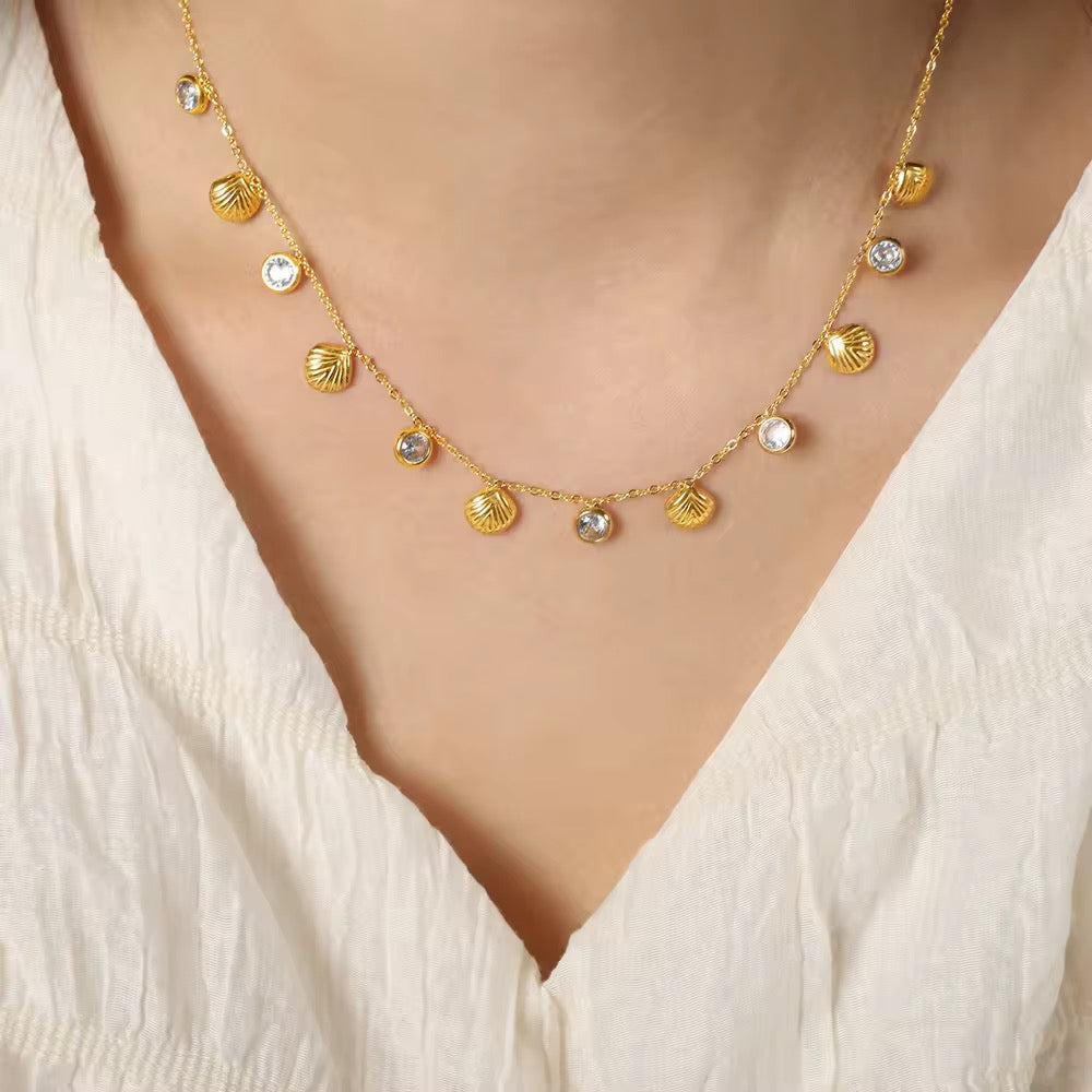 Gold charm necklace with shell and crystal drops, 18k plated design perfect for beach days or casual wear