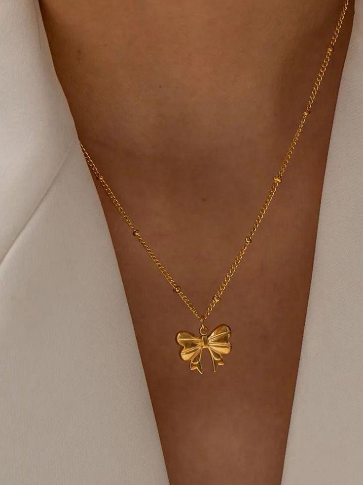 Dainty gold necklace with a sculpted bow charm crafted in anti-tarnish material, great for casual elegance