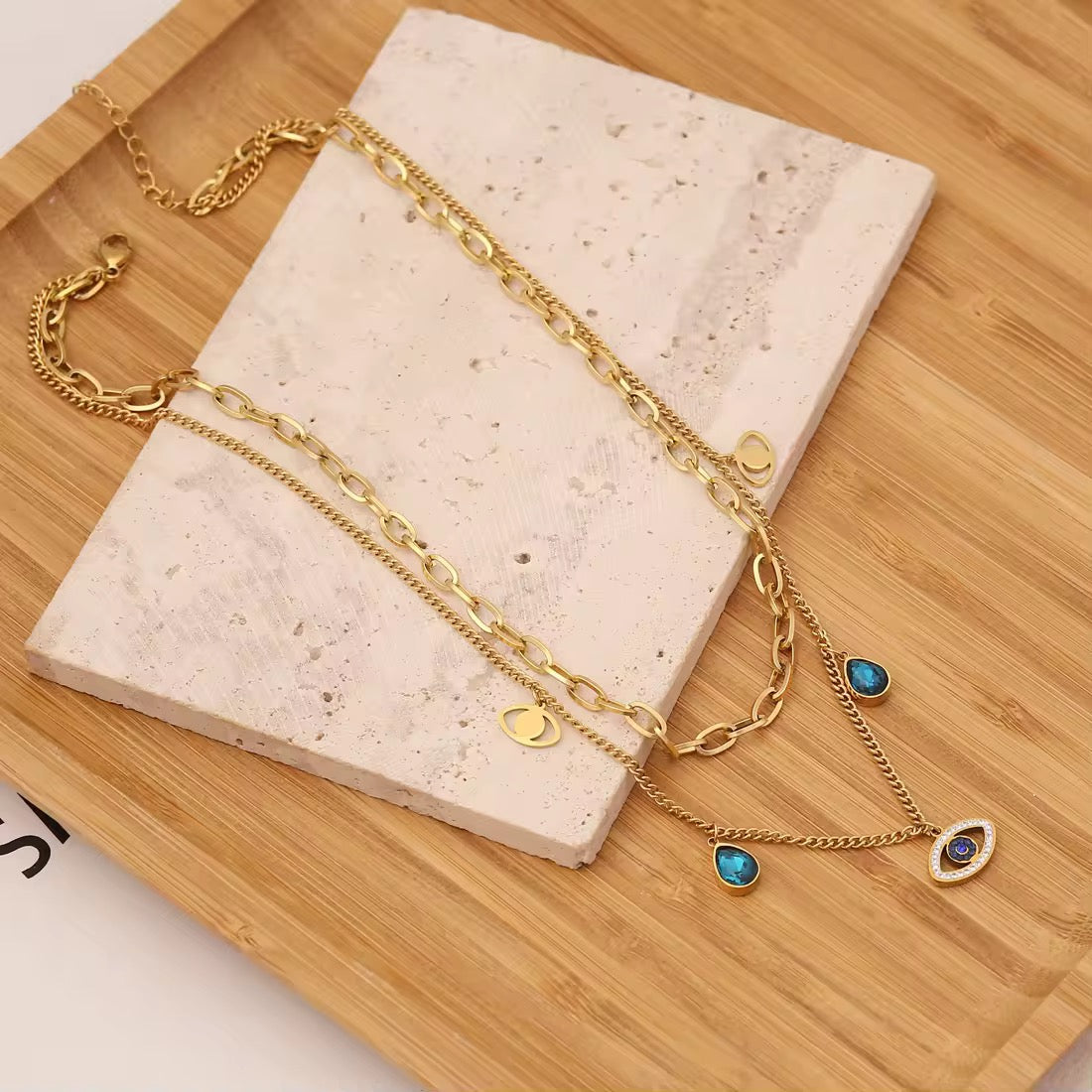 Dainty evil eye charm necklace with polished gold finish, hypoallergenic and great for sensitive skin