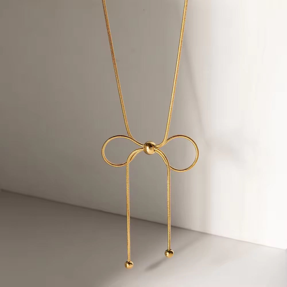 Dainty bow charm necklace with polished gold finish, sweatproof and perfect for everyday minimal styling