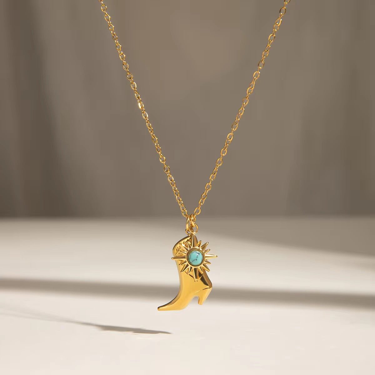 Minimal boot charm necklace with turquoise detail in hypoallergenic gold plated stainless steel for daily wear