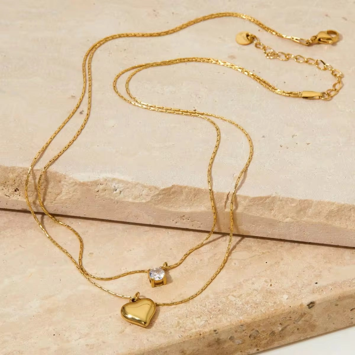 Gold heart charm necklace with dainty layered design, waterproof and anti-tarnish for casual or formal looks