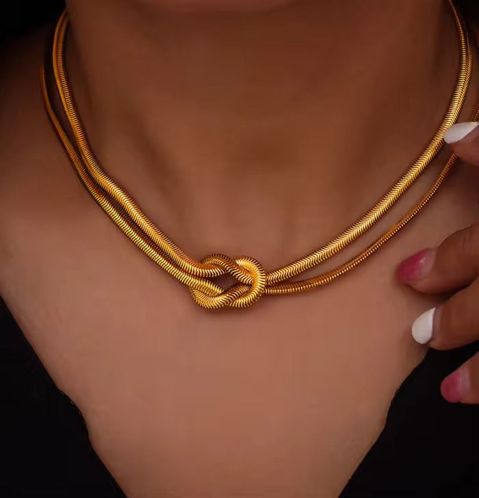 Minimal gold choker with knot feature in waterproof stainless steel, ideal for under 450 daily use