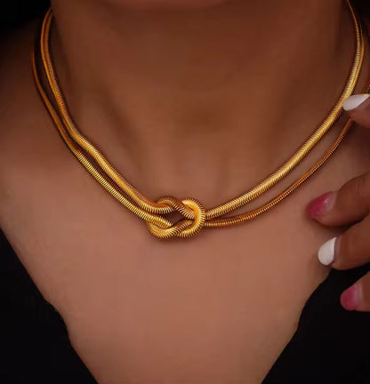 Minimal gold choker with knot feature in waterproof stainless steel, ideal for under 450 daily use